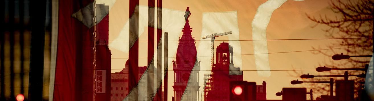 A Temple flag superimposed over an image looking south on Broad Street with City Hall in the center.